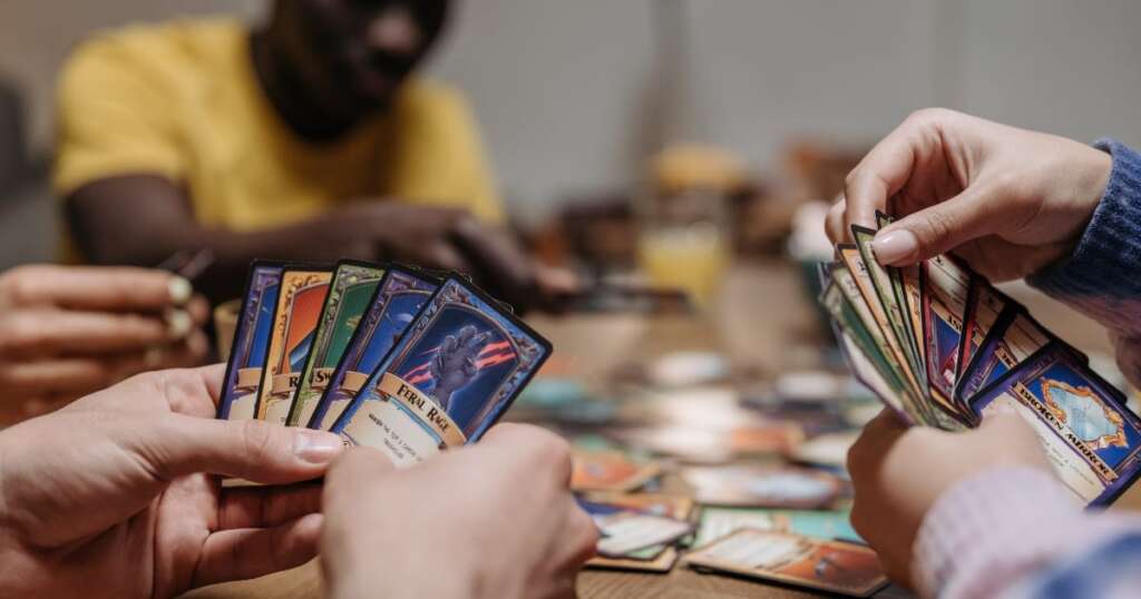 People playing card games on table_gameworld.co.ke