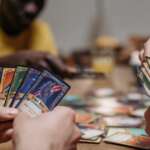 People playing card games on table_gameworld.co.ke